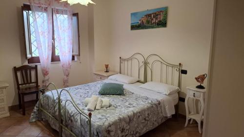 a bedroom with a bed with two towels on it at Capocanto Rooms in Camerota
