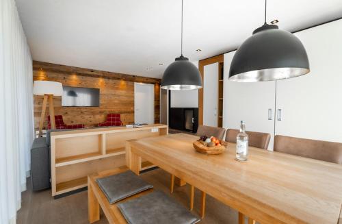 a kitchen and dining room with a wooden table at Das.Hochgrat in Oberstaufen