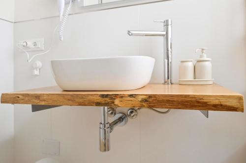 a bathroom with a sink on a wooden shelf at RELAIS DELL'USSERO Pisa centro in Pisa