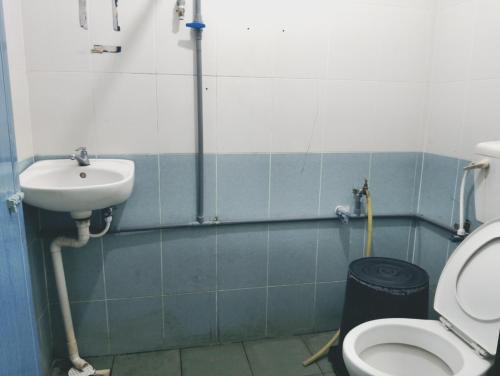a bathroom with a sink and a toilet at Dales Guest House in Perai