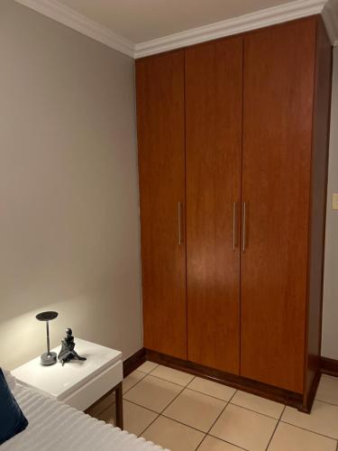 a bedroom with a large wooden cabinet and a bed at Maison Ruvimbo in Vosburg