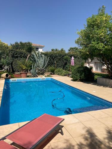 une piscine avec un banc rouge à côté dans l'établissement Studio Lumineux 2 adultes et 1enfant, à Lunel