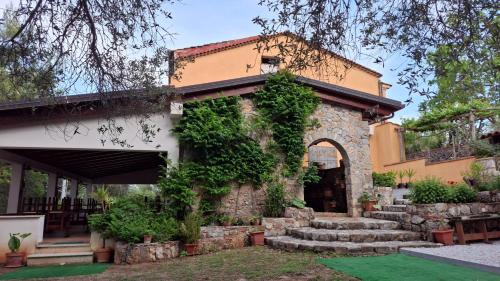 a building with an arch and stairs in front of it at Capocanto Rooms in Camerota