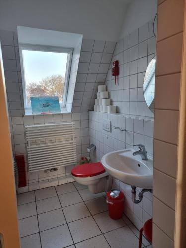 a small bathroom with a toilet and a sink at Kattenwarft OG in Böhl