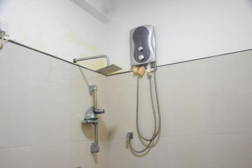 a shower in a bathroom with a shower head at CFC Holiday Home in Anuradhapura