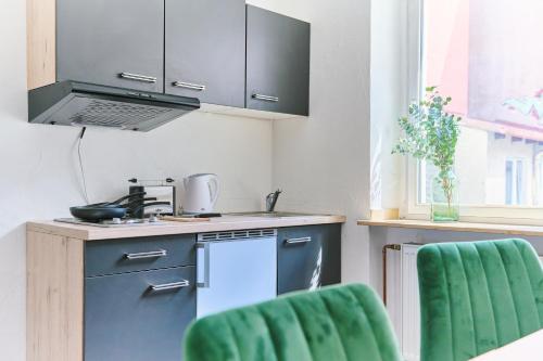 a kitchen with a sink and a stove top oven at Schwanthaler Hof in Munich