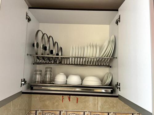 a kitchen with plates and dishes on shelves at El Amanecer in Choachí