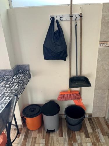 a room with buckets and a black bag on a wall at El Amanecer in Choachí