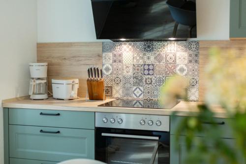 a kitchen with a stove and a counter top at Fewo Eickhorst in Menslage