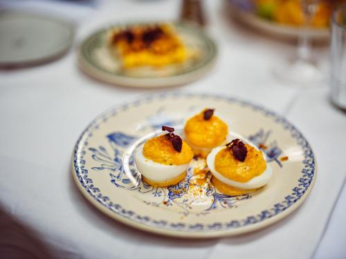a plate with three deviled eggs on a table at Hôtel Eldorado Paris in Paris