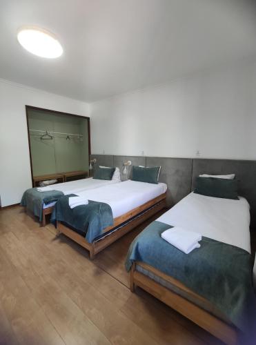 two beds in a room with two beds sidx sidx sidx at Old Village Hostel in Ponte de Lima