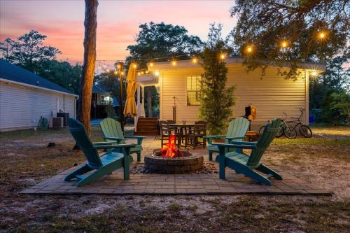 a patio with chairs and a fire pit at Modern Oak Island Escape 1 Mile to Long Beach! in Oak Island