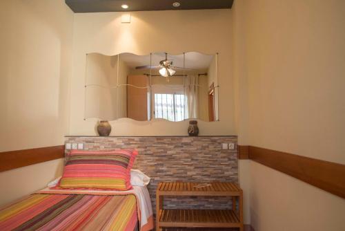 a bedroom with a bed and a mirror at Las Casas de Nani in Beas de Segura