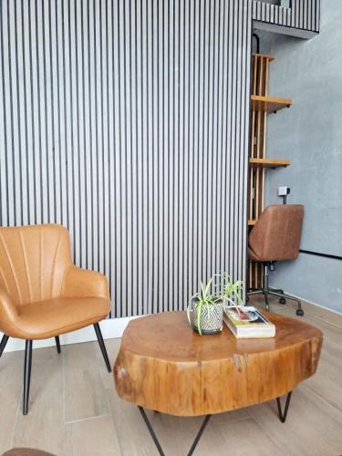 a living room with a chair and a wooden coffee table at Departamento Zona Centro in Monterrey