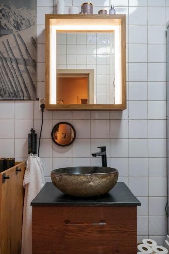 a bathroom with a stone sink and a mirror at Beitostølen! Midt i sentrum! Ski in ski out! Badstue-Massasjedusj-Steamdusj in Beitostøl