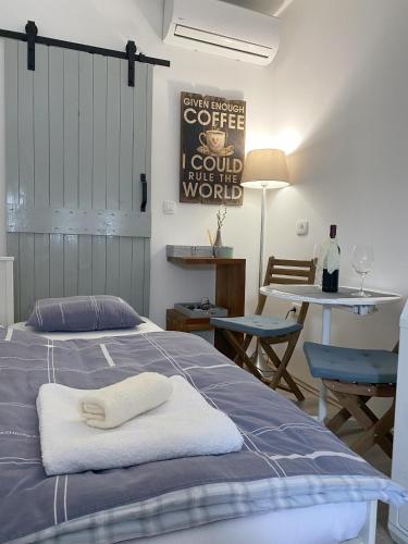 a bedroom with a bed and a table with chairs at Apartman Zeljka in Pula