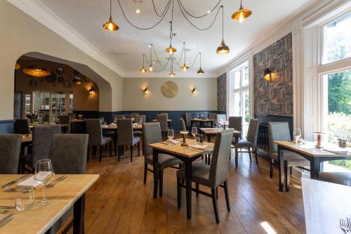 a restaurant with wooden tables and chairs and windows at Best Western Valley Hotel in Ironbridge