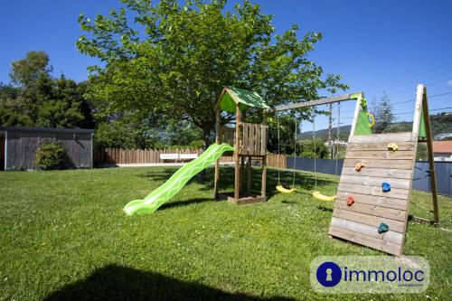 a playground with a green slide in a yard at Air-conditioned villa with pool and garden in Mandelieu-la-Napoule