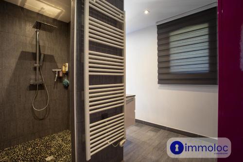 a bathroom with a shower with a shower curtain at Air-conditioned villa with pool and garden in Mandelieu-la-Napoule