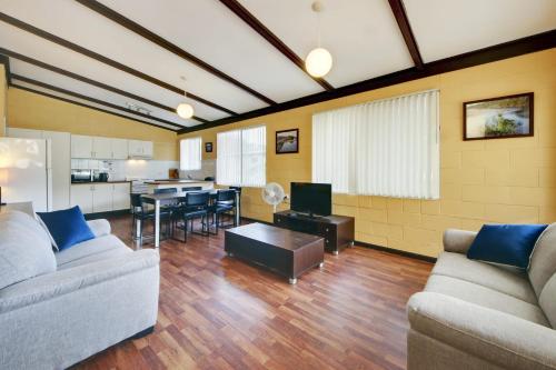 a living room with two couches and a dining room at Bella Beach 575-77 Straight St Hat Head in Hat Head