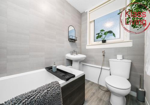 a bathroom with a toilet and a sink at Colt Apartment by Klass Living Coatbridge in Glenboig