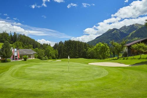 a view of a golf course with a green at Das Goldjuwel - Luxury Apartments with private Spa in Goldegg