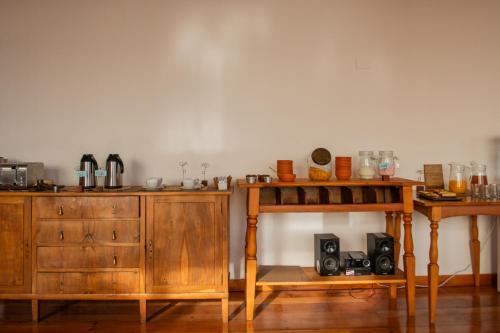 a kitchen with wooden cabinets and a table and a table at Del Lago Sky Hotel in San Carlos de Bariloche