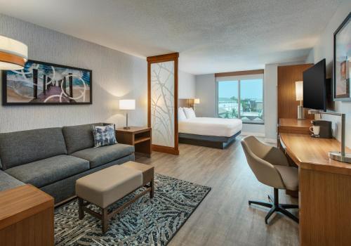a hotel room with a couch and a bed at Hyatt Place Dewey Beach in Dewey Beach