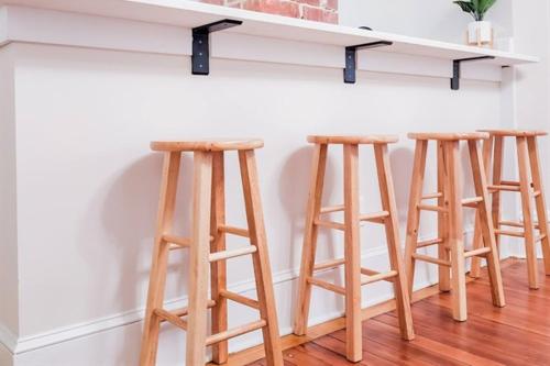 a group of three bar stools under a counter at Luxury Beach Getaway in Cape Charles in Cape Charles