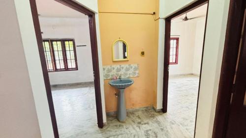 a bathroom with a sink in the middle of a room at Empire Hostel in Ernakulam