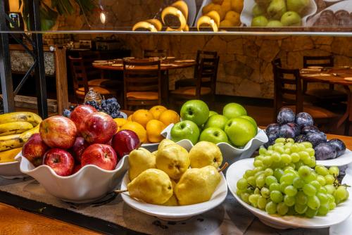 a display of fruits and vegetables in bowls on a table at Sanma Hotel in Foz do Iguaçu