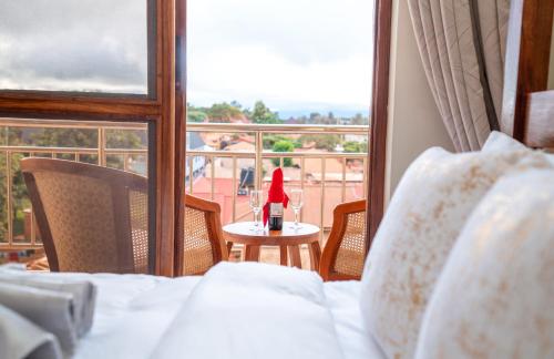 a bedroom with a bed and a table with a santa hat at Skylark Hotel in Karatu