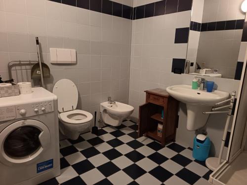 a bathroom with a washing machine and a sink at Soul Flat in Trento