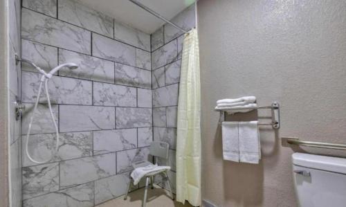 a bathroom with a shower and a toilet at Studio 6 Little Rock AR South in Little Rock