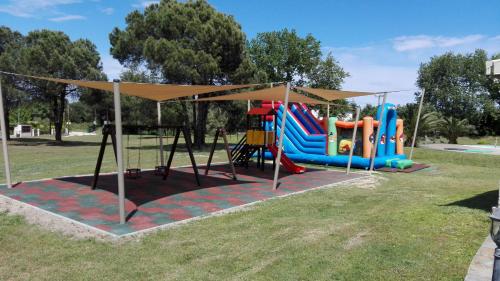 a playground in a park with a slide at Top Studios in Vourvourou