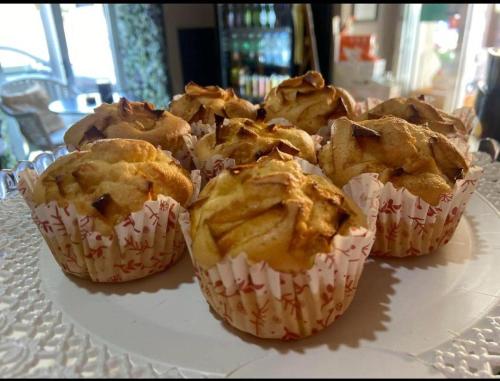 four muffins sitting on a plate on a table at l'angolo di Gaudì, alcoba Fascinosa in Putignano