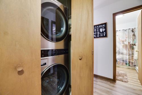a washer and dryer in a room with a mirror at Serenity and Fun all in one in this Cozy Pocono Cabin in Jim Thorpe