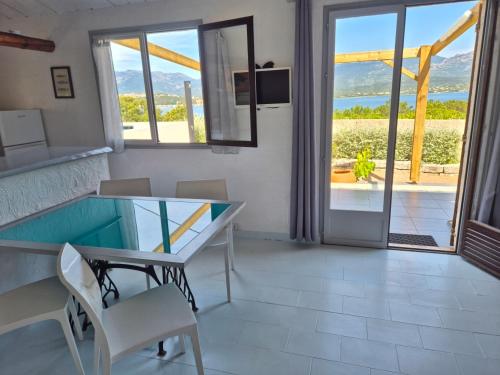 a dining room with a table and a view of the ocean at Altaria in Porto-Vecchio