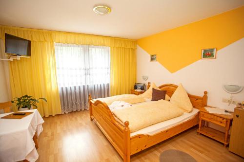 a bedroom with a bed and a large window at Auerhahn Bed and Breakfast - Black Forest - Waldhotel in Eisenbach