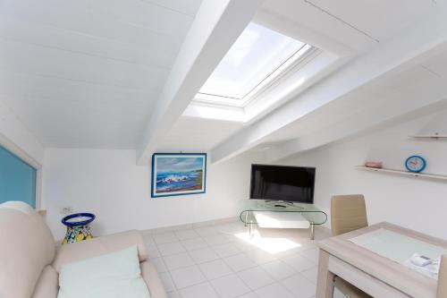 a living room with a couch and a tv at Agropoli Home in Agropoli