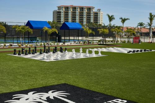 a giant chess game in a park with a building at Palmetto Marriott Resort & Spa in Palmetto