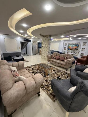 a large living room with couches and a rug at شقة فندقية in Cairo