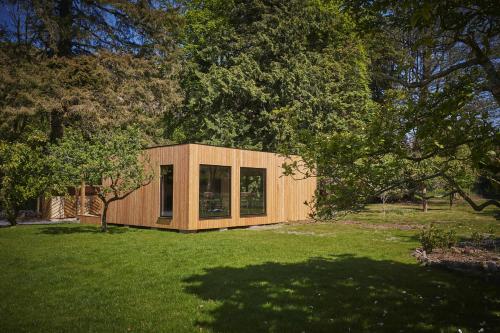 a small wooden house in a field of grass at Eskdale Retreat in Holmrook