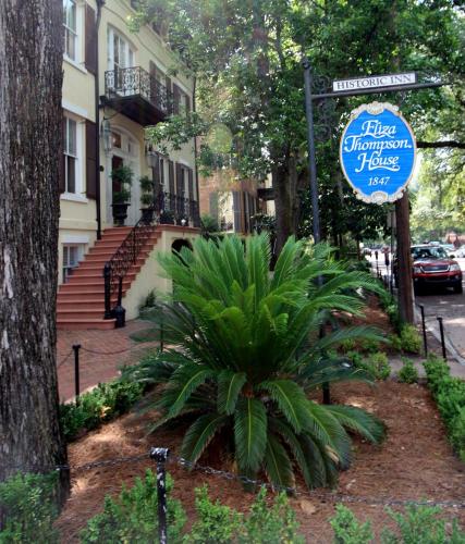 a sign in front of a house with a plant at Eliza Thompson House, Historic Inns of Savannah Collection in Savannah