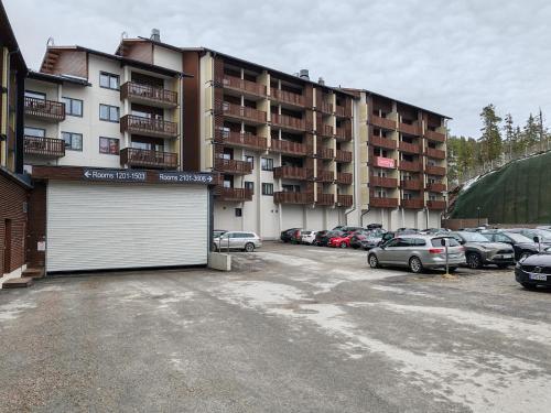 a parking lot in front of a large apartment building at Ruka chalets 2 in Kuusamo