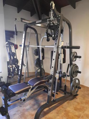 a gym with a squat rack and weights at Aruba , Eagle Beach Townhouse in Palm-Eagle Beach