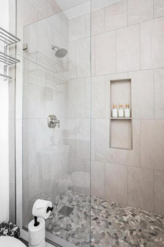 a bathroom with a shower with a glass door at Chic Studio Close to Harbor Point in Stamford