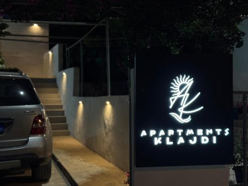 a sign for a car parked in front of a building at Apartments Klajdi in Sarandë
