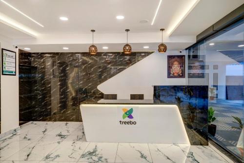 a lobby of a hotel with a marble counter at Treebo Address Inn Gachibowli in Hyderabad