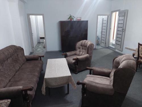a living room with a couch and chairs and a tv at Suny Sevan in Sevan